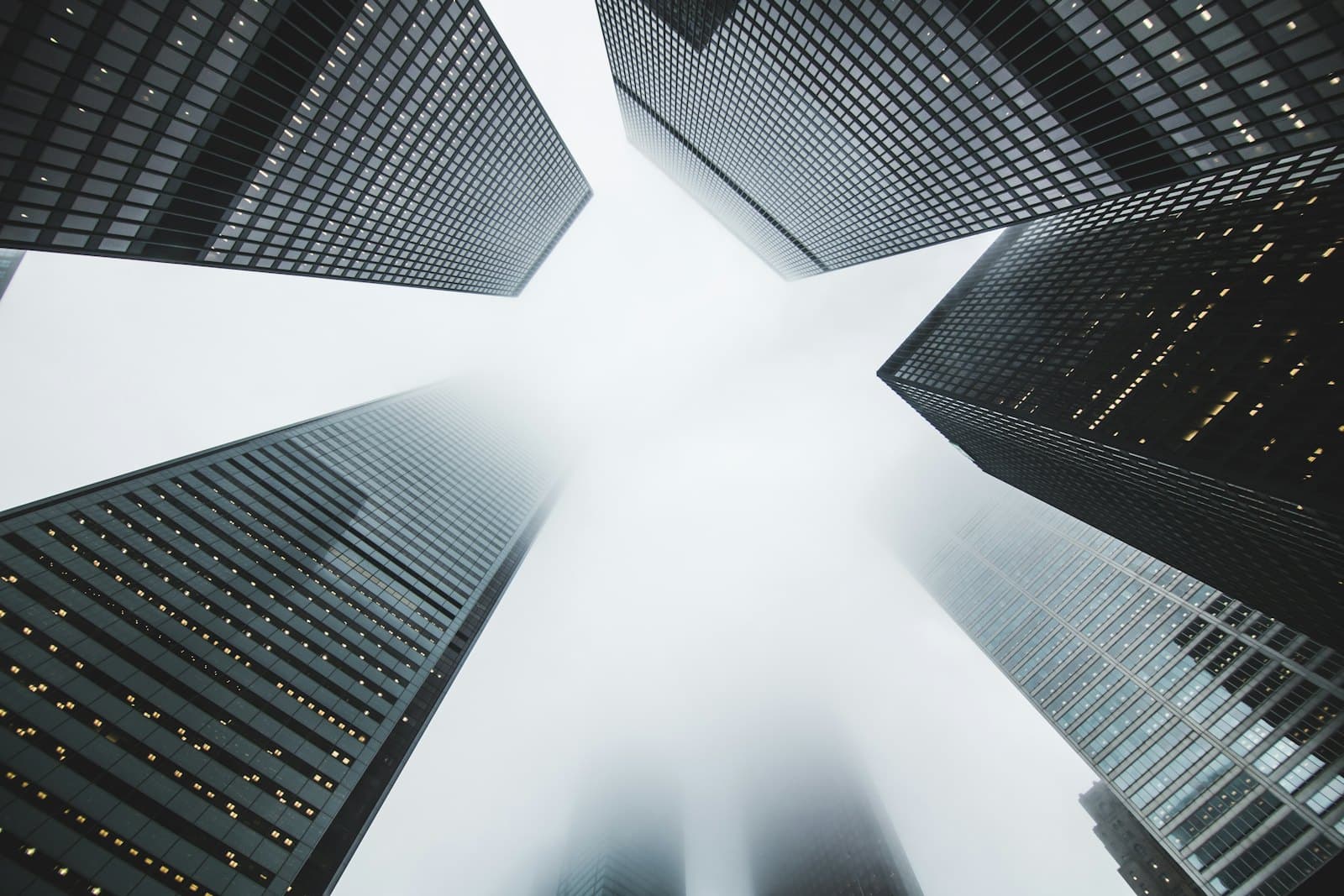 Commercial buildings rising into low cloud